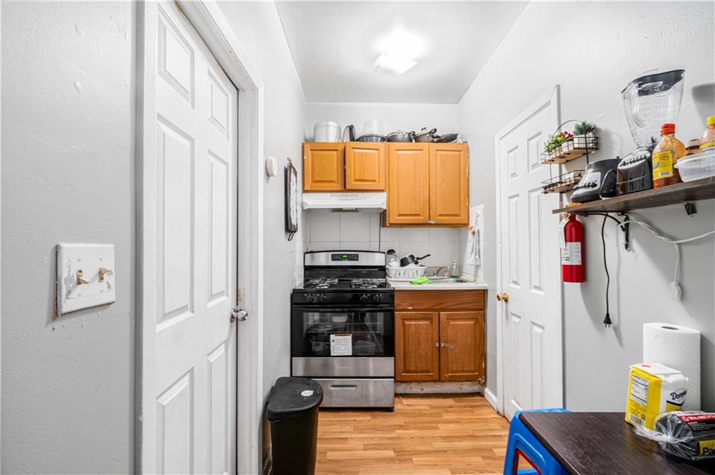 142 Neptune Avenue Brooklyn, NY 11235 - Photo 12 of 17 a kitchen with stainless steel appliances granite countertop a refrigerator and a stove