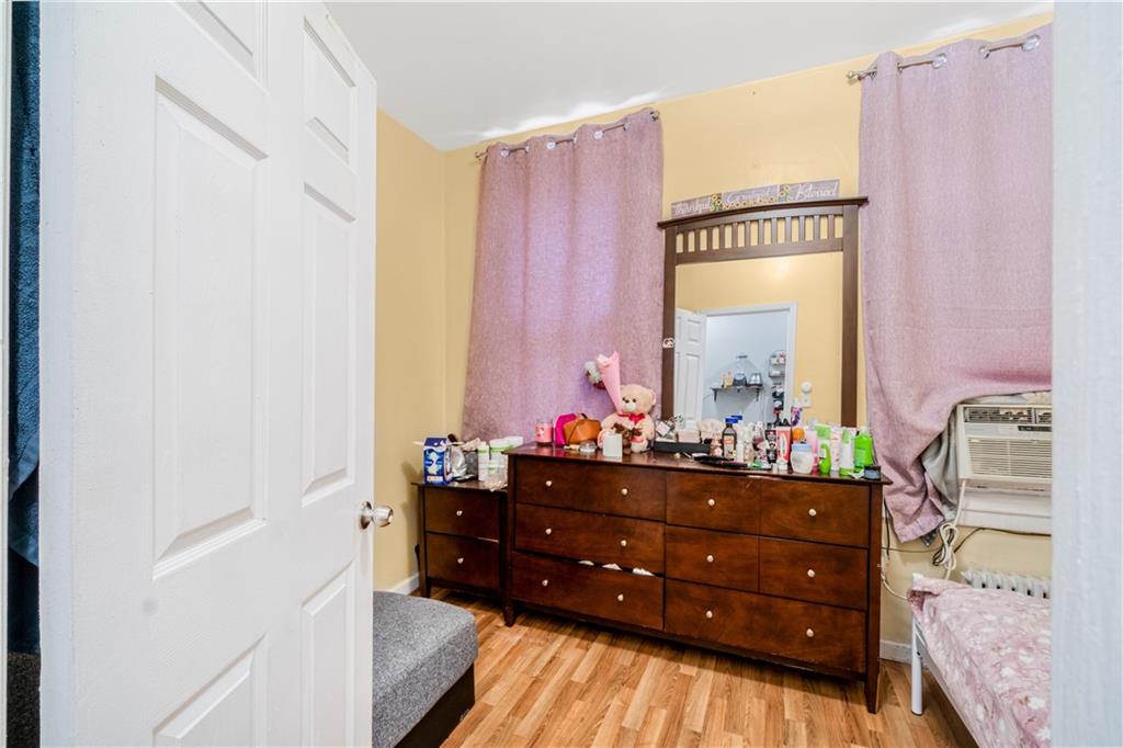 142 Neptune Avenue Brooklyn, NY 11235 - Photo 14 of 17 a room with a dresser and a window