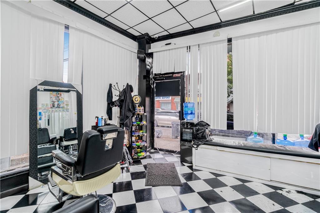 142 Neptune Avenue Brooklyn, NY 11235 - Photo 17 of 17 a room with gym equipment and mirror