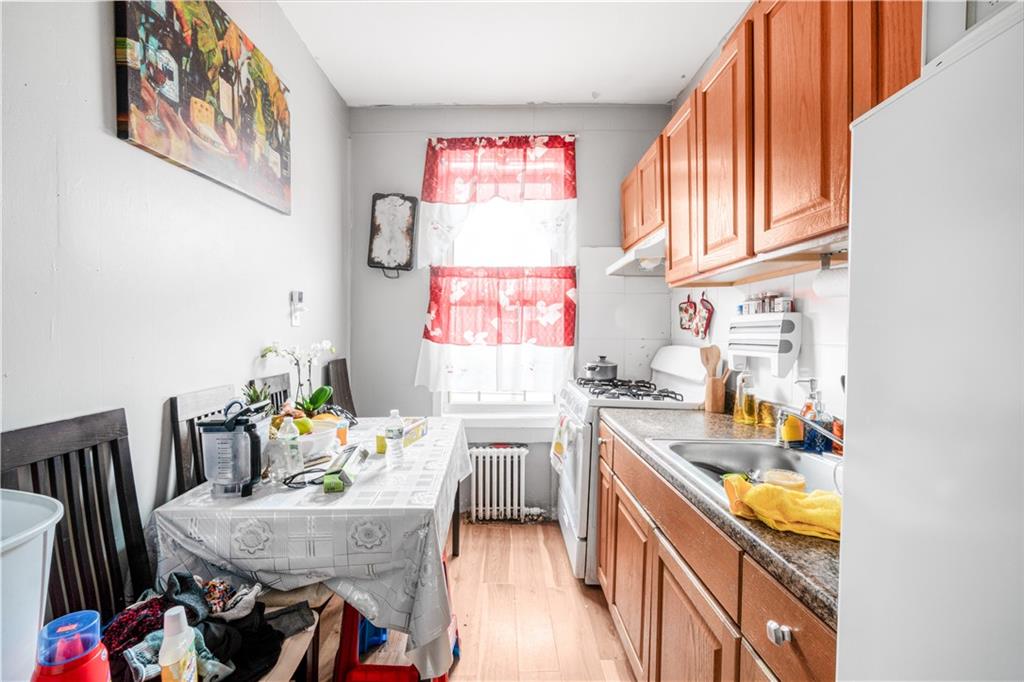 142 Neptune Avenue Brooklyn, NY 11235 - Photo 4 of 17 a kitchen with stainless steel appliances granite countertop a stove and a dining table