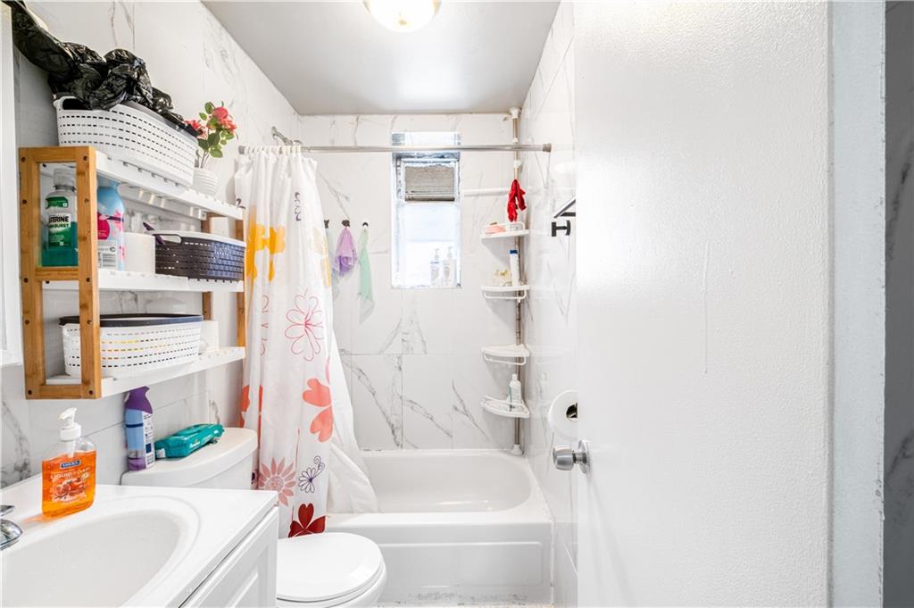 142 Neptune Avenue Brooklyn, NY 11235 - Photo 5 of 17 a bathroom with a sink toilet and bathtub