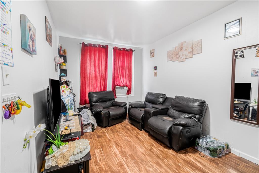 142 Neptune Avenue Brooklyn, NY 11235 - Photo 6 of 17 a living room with furniture windows and a flat screen tv