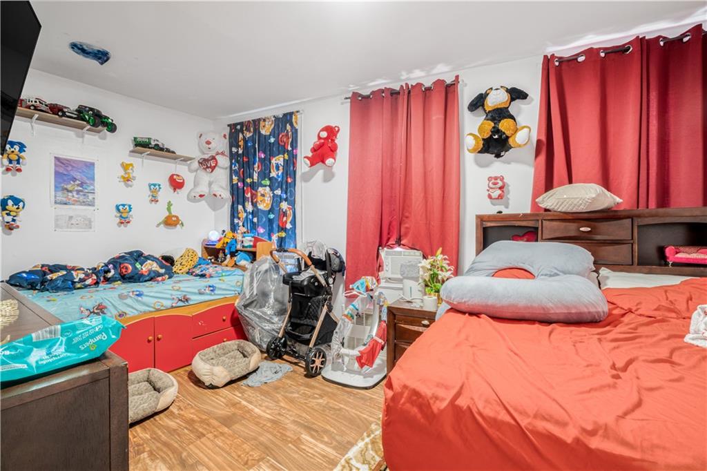 142 Neptune Avenue Brooklyn, NY 11235 - Photo 7 of 17 a bedroom with bed and a bed