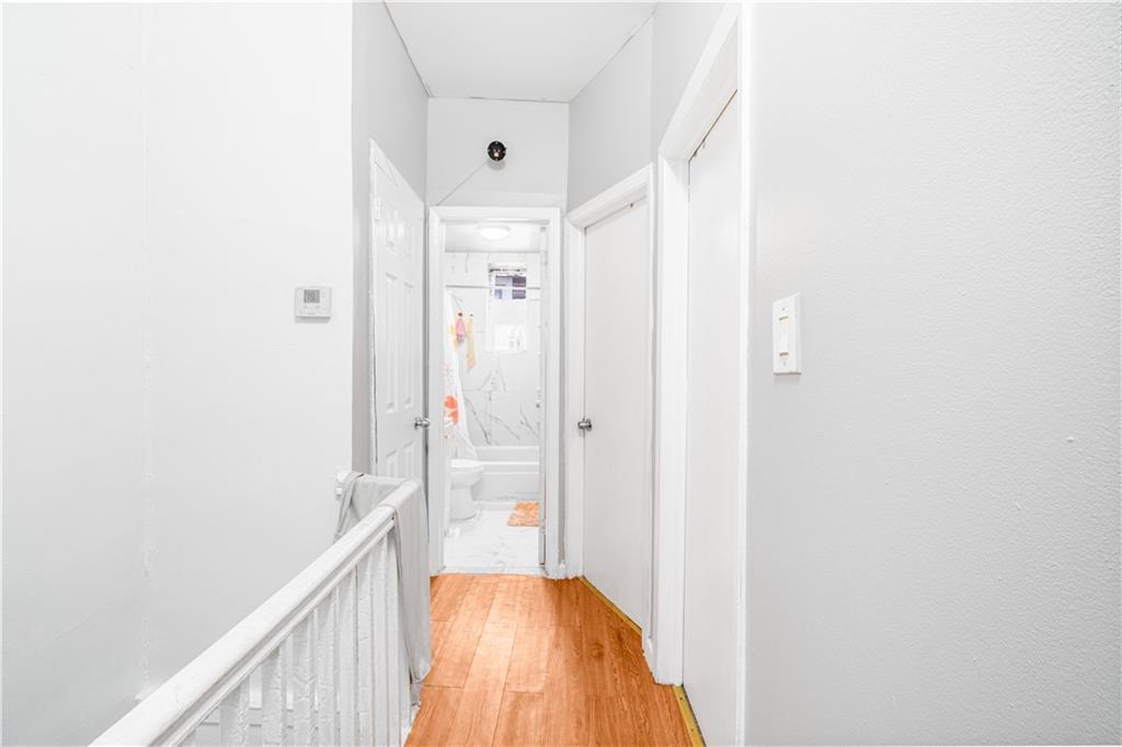 142 Neptune Avenue Brooklyn, NY 11235 - Photo 8 of 17 a view of a hallway with wooden floor