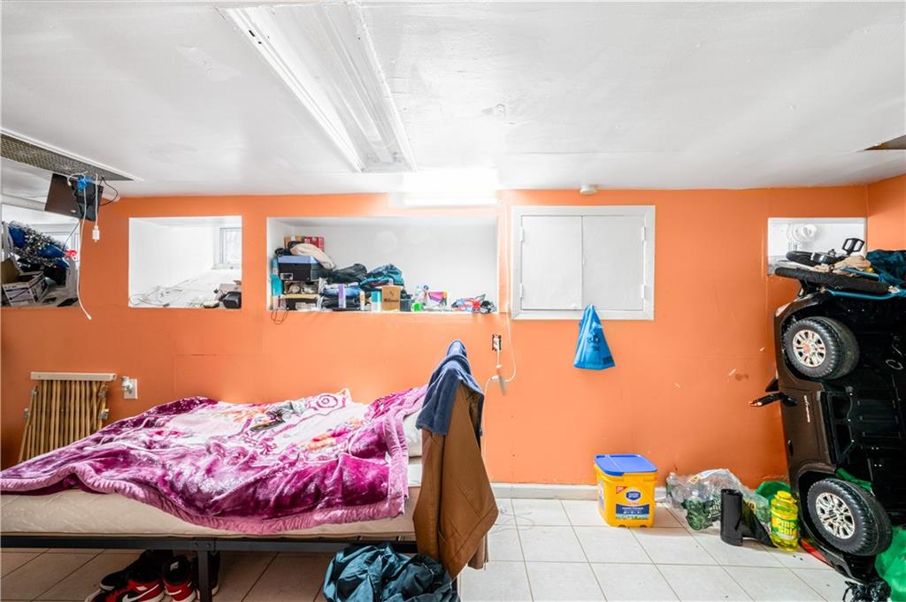 142 Neptune Avenue Brooklyn, NY 11235 - Photo 10 of 17 a bedroom with a bed and dresser