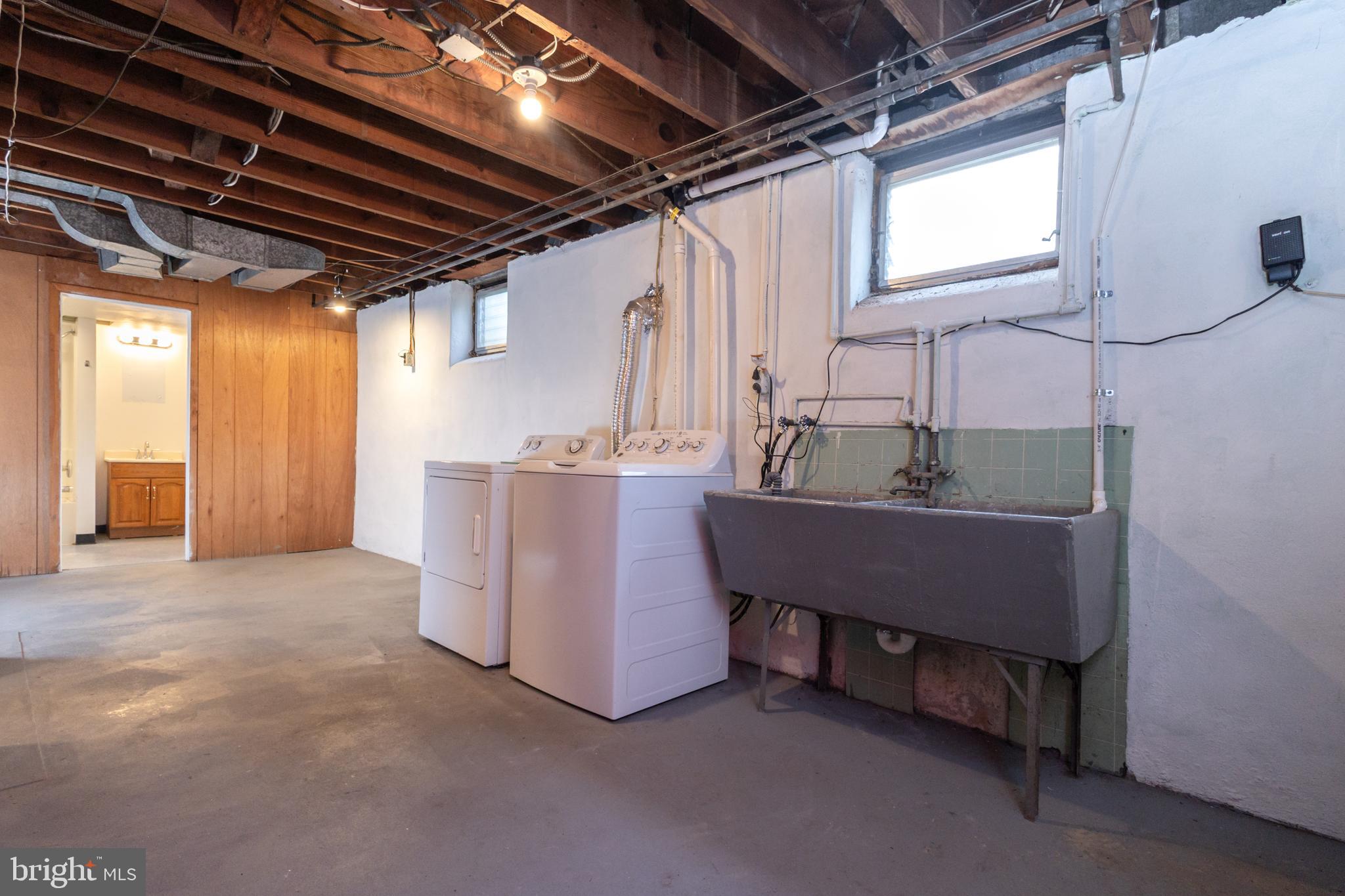 312 North Highland Street Arlington, VA 22201 - Photo 29 of 33 a room with water heater and wooden cabinets