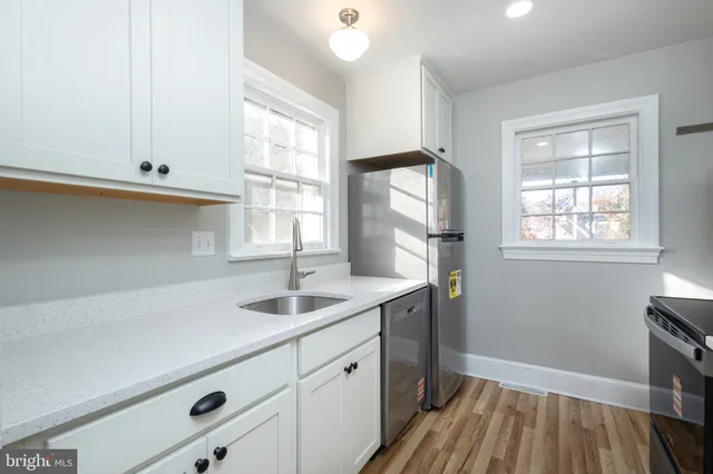 a kitchen with a sink and cabinets