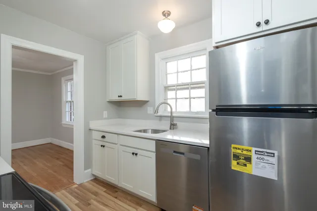 a kitchen with a refrigerator and a sink