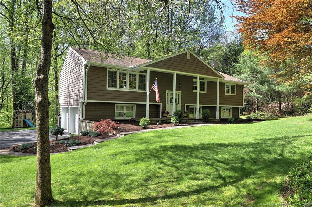 a front view of a house with a yard and porch