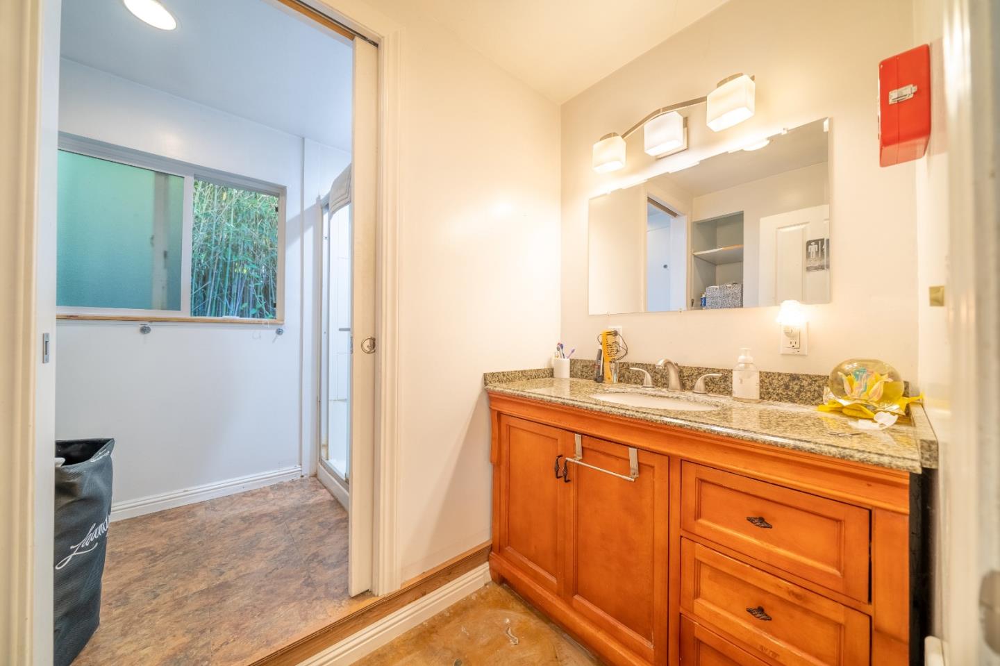 41 Varni Road Watsonville, CA 95076 - Photo 41 of 59 a bathroom with a granite countertop sink and a mirror