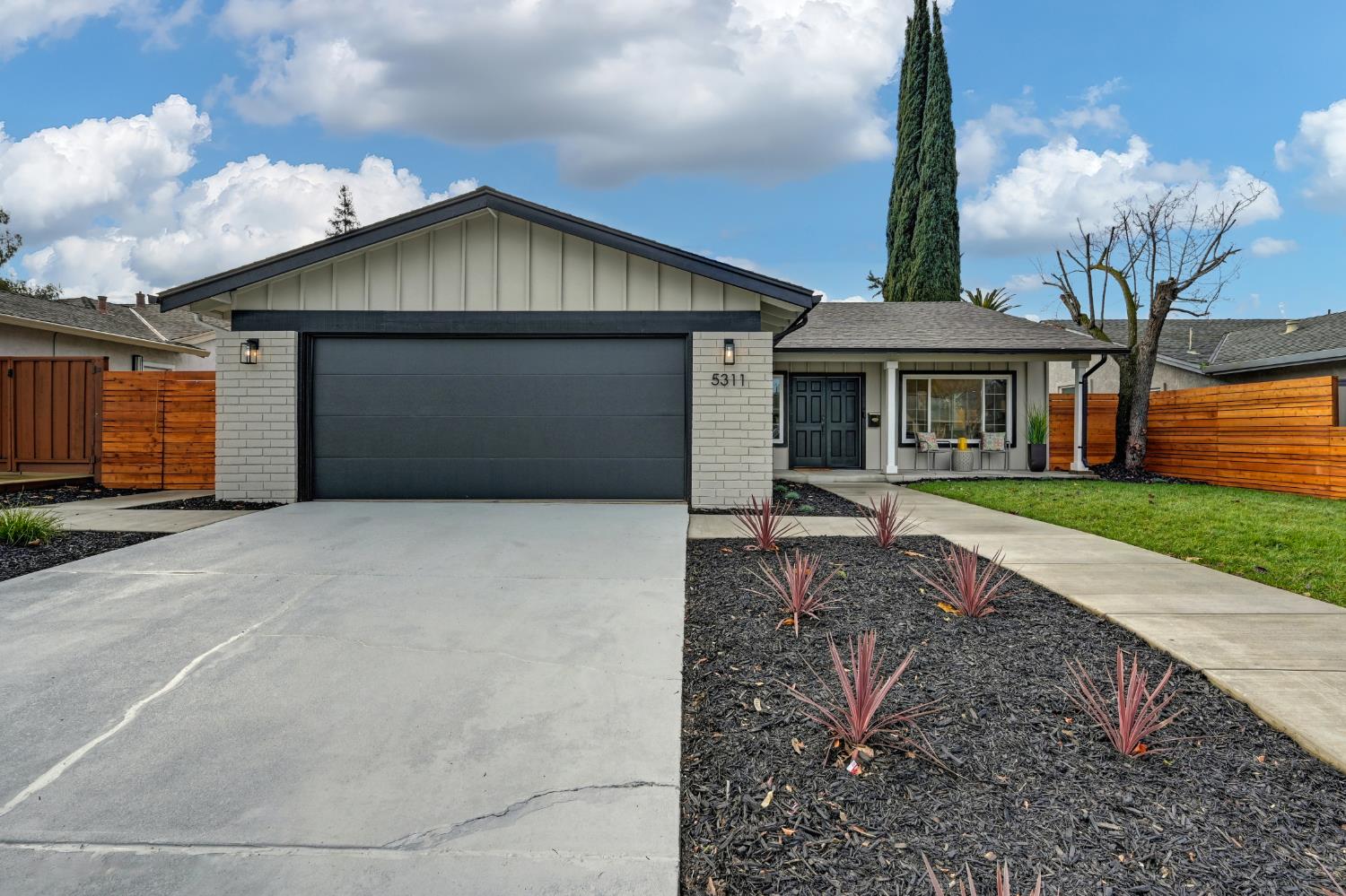 5311 Charlotte Way Livermore, CA 94550 - Photo 1 of 1 a front view of a house with a yard and garage