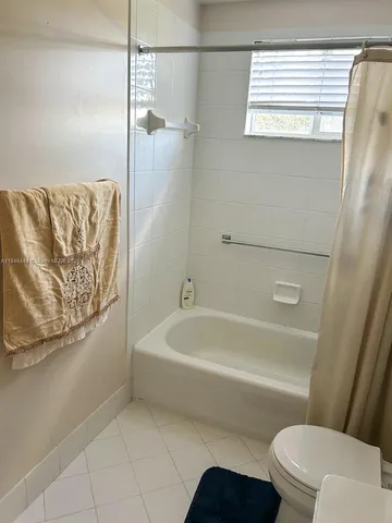 a bathroom with a bathtub and a toilet