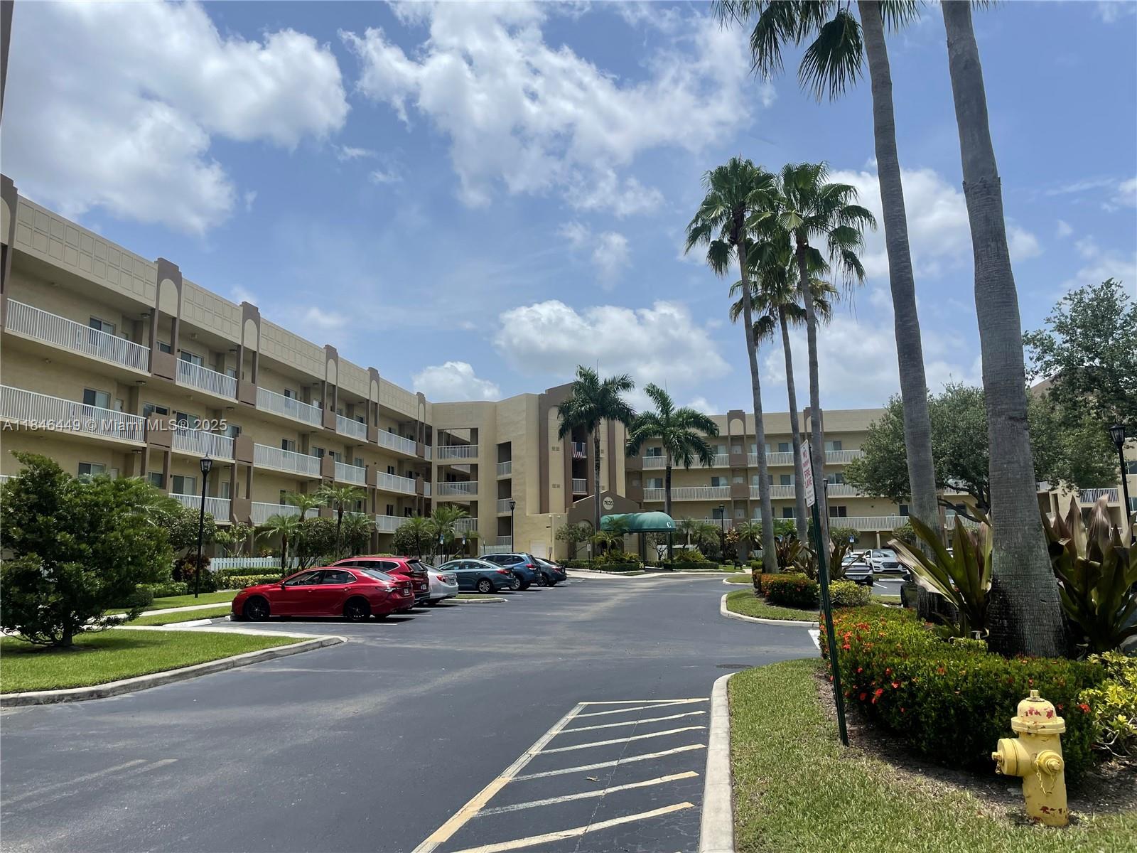 7635 Southampton Terrace, Unit 201 Tamarac, FL 33321 - Photo 20 of 23 a building view with couches and palm trees
