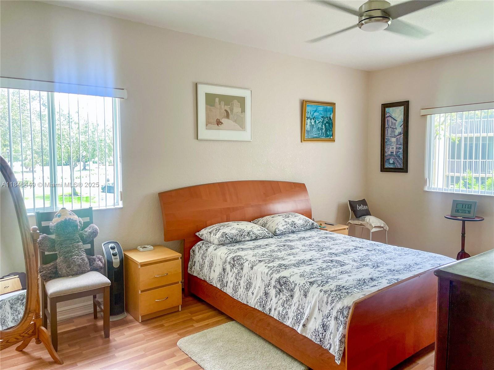 7635 Southampton Terrace, Unit 201 Tamarac, FL 33321 - Photo 5 of 23 a bedroom with a bed chair and window