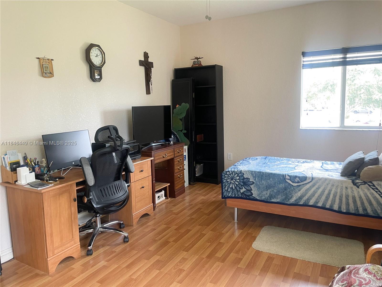 7635 Southampton Terrace, Unit 201 Tamarac, FL 33321 - Photo 10 of 23 a bedroom with a workspace