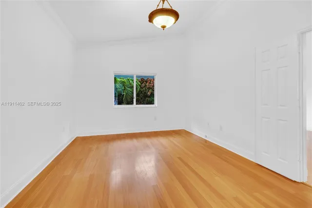 a view of a room with wooden floor and window