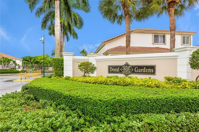 a view of front house with palm trees
