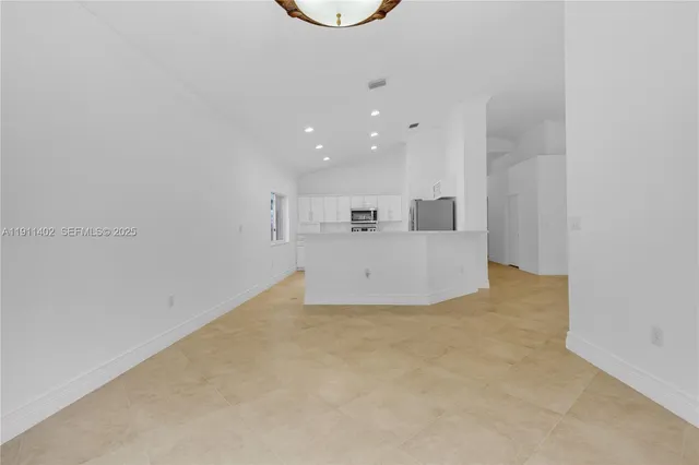 a view of kitchen and hall with wooden floor