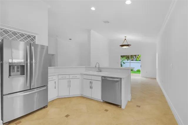 a kitchen with stainless steel appliances a refrigerator and a stove