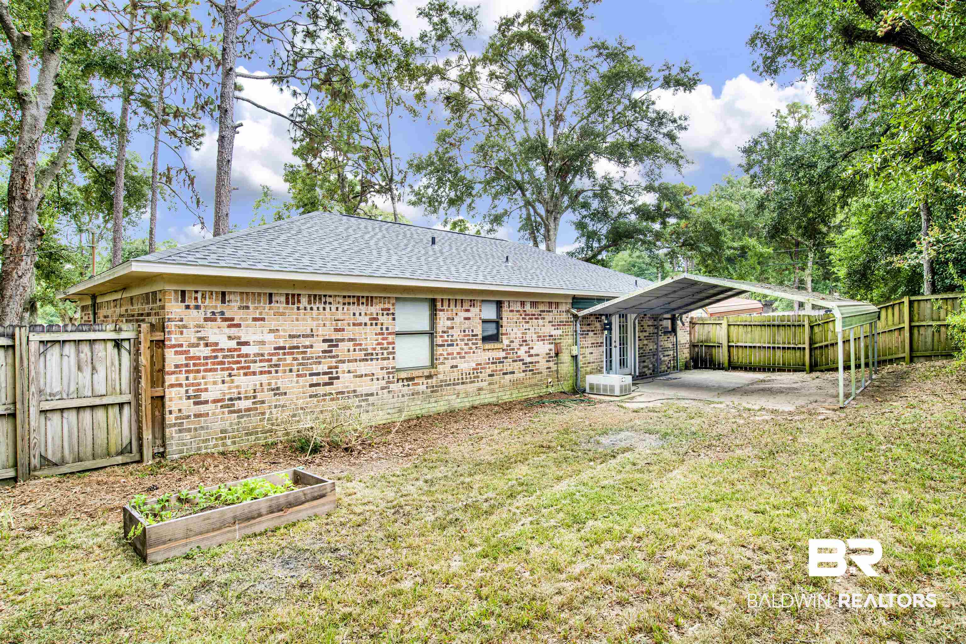 3560 Creekway Road Mobile, AL 36619 - Photo 24 of 24 Back of house featuring central AC unit, a yard, and a patio area