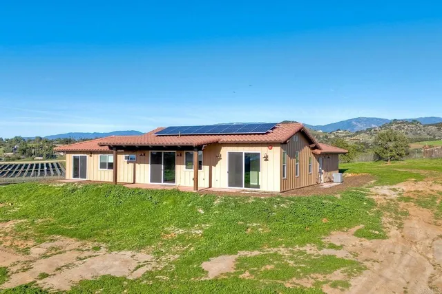 a front view of a house with a garden and yard