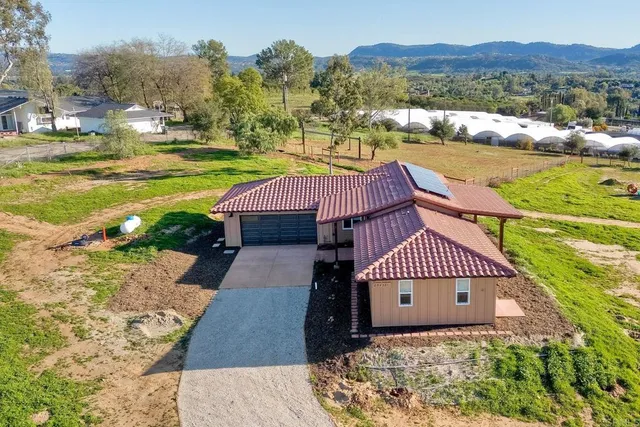 a aerial view of a house with a yard