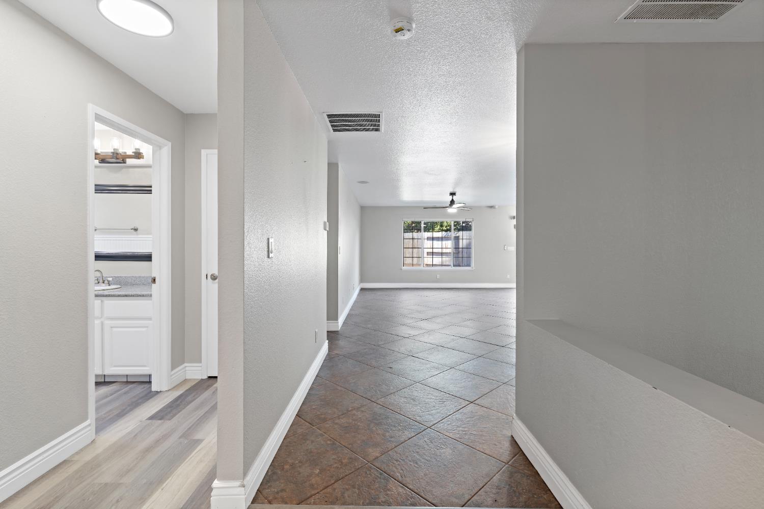 2903 Raintree Court Stockton, CA 95219 - Photo 8 of 34 a view of a hallway with a cabinet and a window