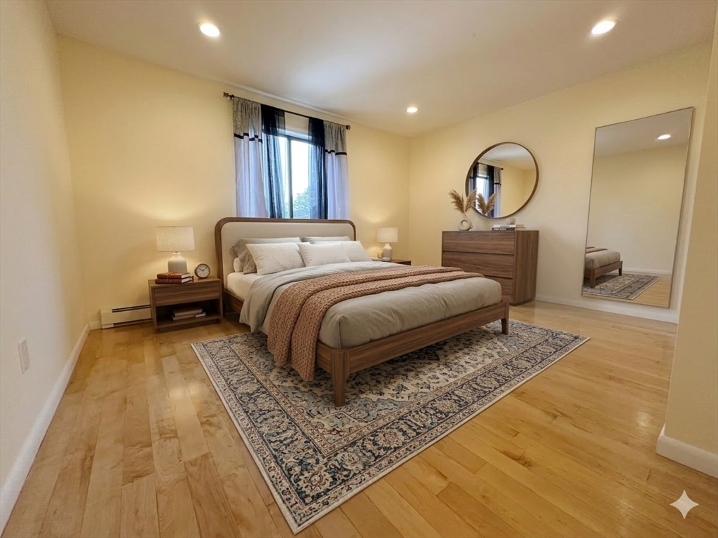 740 Farm Road, Unit 211 Marlborough, MA 01752 - Photo 1 of 6 a bedroom with a large bed and a dresser