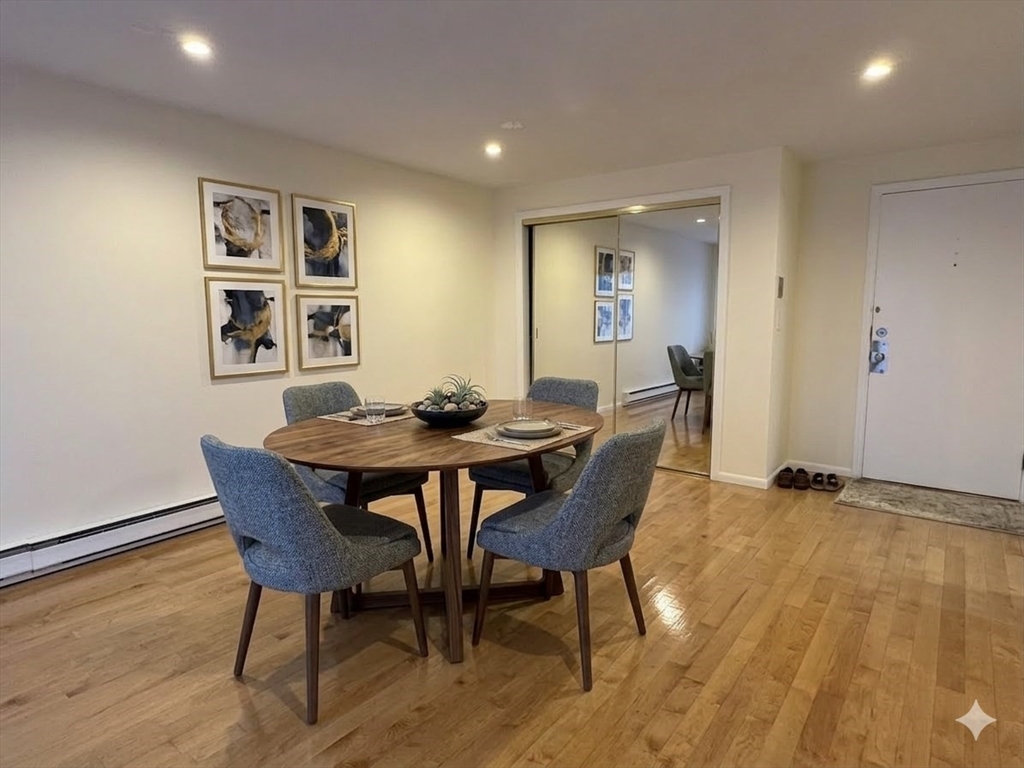 740 Farm Road, Unit 211 Marlborough, MA 01752 - Photo 2 of 6 a view of a dining room with furniture and wooden floor