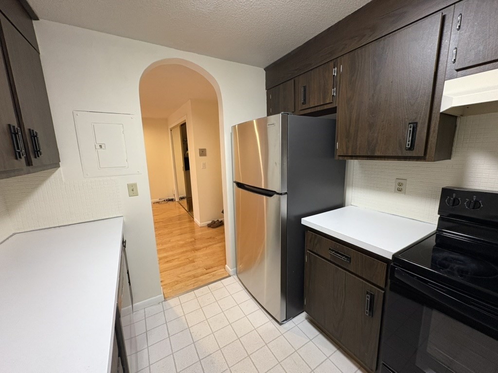 740 Farm Road, Unit 211 Marlborough, MA 01752 - Photo 4 of 6 a kitchen with stainless steel appliances a refrigerator and a stove