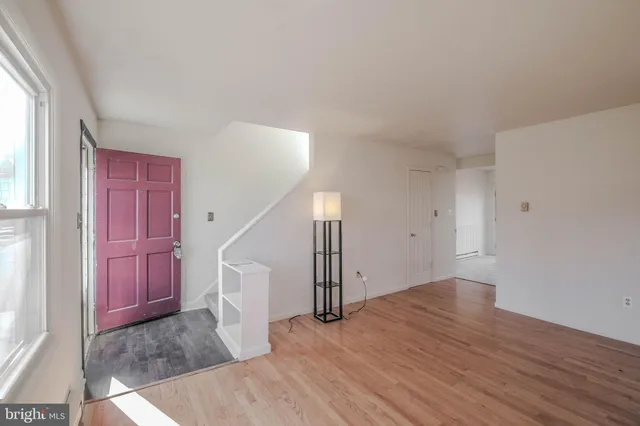 a bathroom with a sink a light fixture and a mirror