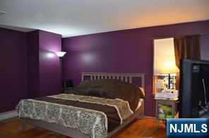 442 Elbert Street Ramsey, NJ 07446 - Photo 5 of 9 a bedroom with a bed and a flat tv screen on dresser