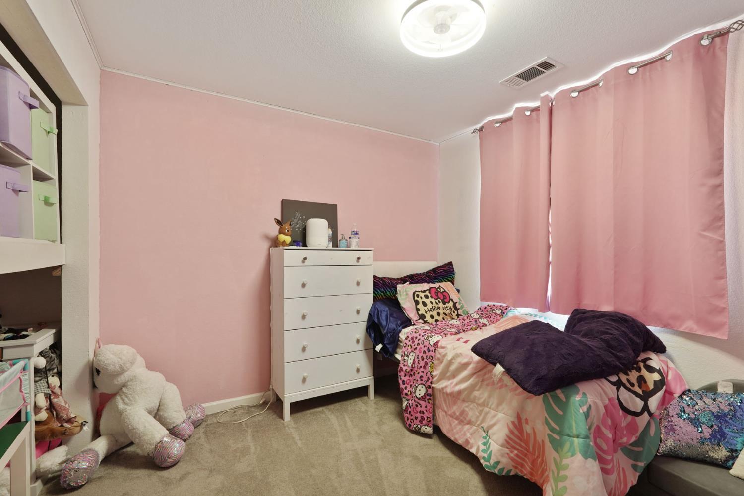 242 3rd Street Galt, CA 95632 - Photo 13 of 31 a bedroom with a bed and a window