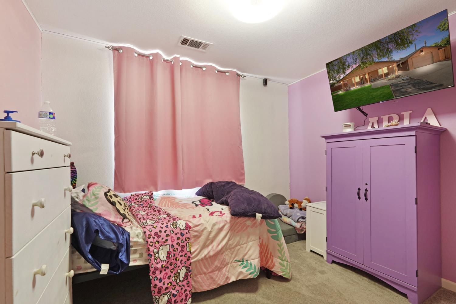 242 3rd Street Galt, CA 95632 - Photo 19 of 31 a bedroom with a bed and a flat screen tv