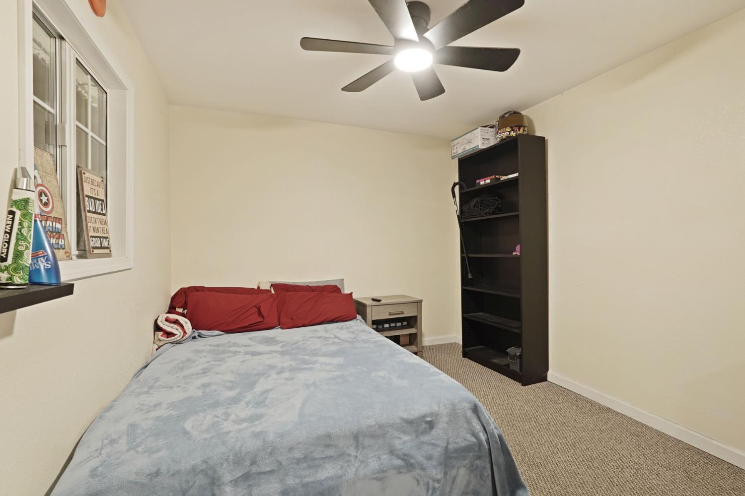 242 3rd Street Galt, CA 95632 - Photo 22 of 31 a bedroom with a bed and a chandelier