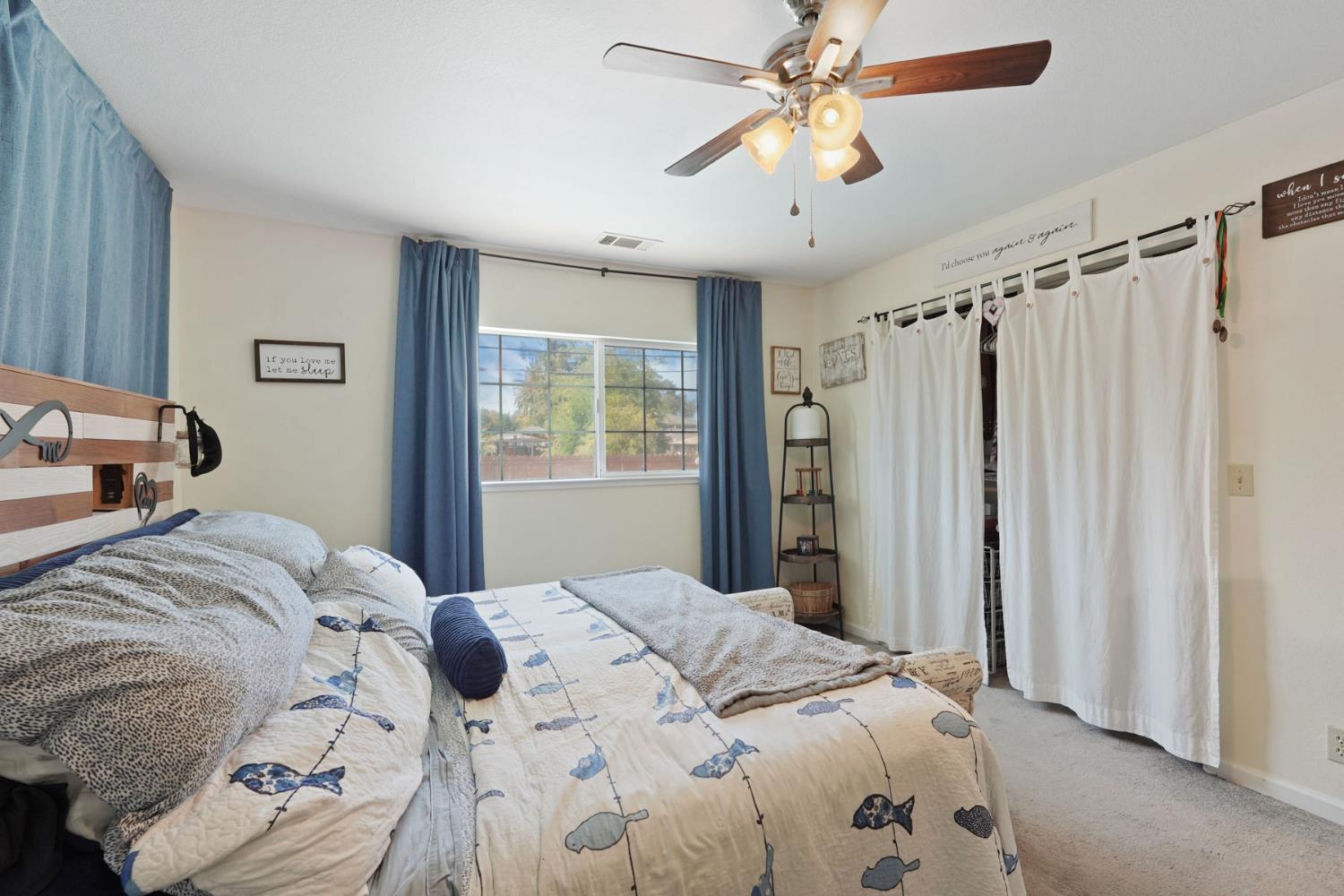 242 3rd Street Galt, CA 95632 - Photo 23 of 31 a bedroom with a large bed and a chandelier