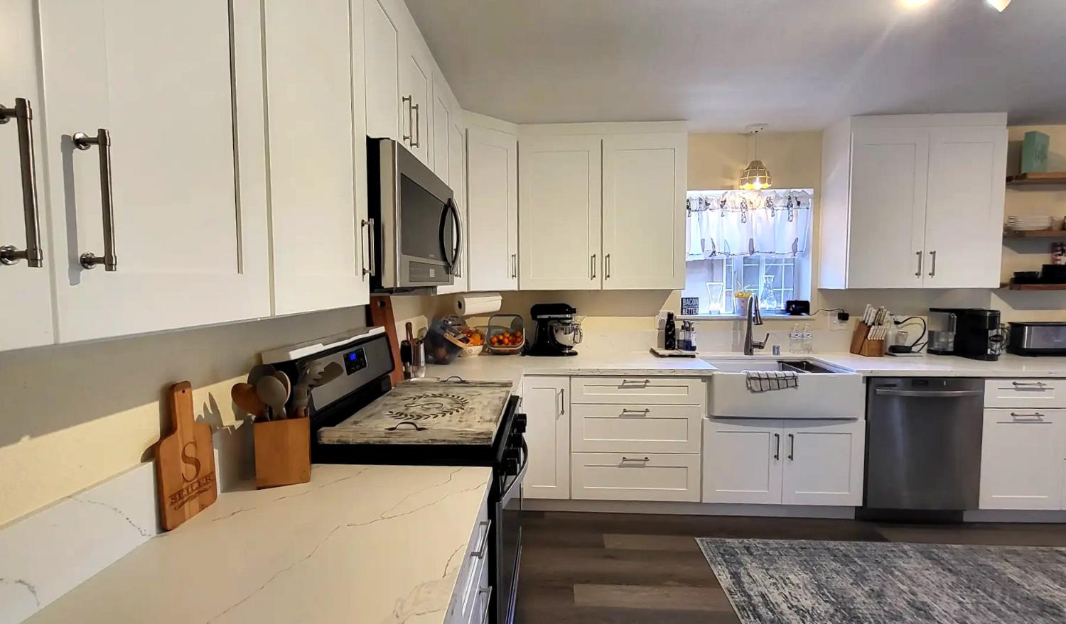 242 3rd Street Galt, CA 95632 - Photo 8 of 31 a kitchen with stainless steel appliances granite countertop a stove a sink and a white cabinets
