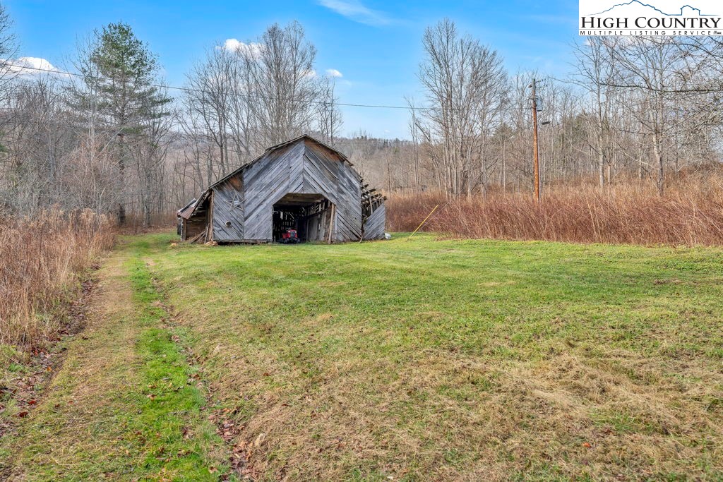 9716 3 Top Road Todd, NC 28684 - Photo 6 of 23 a big house with a big yard and large trees