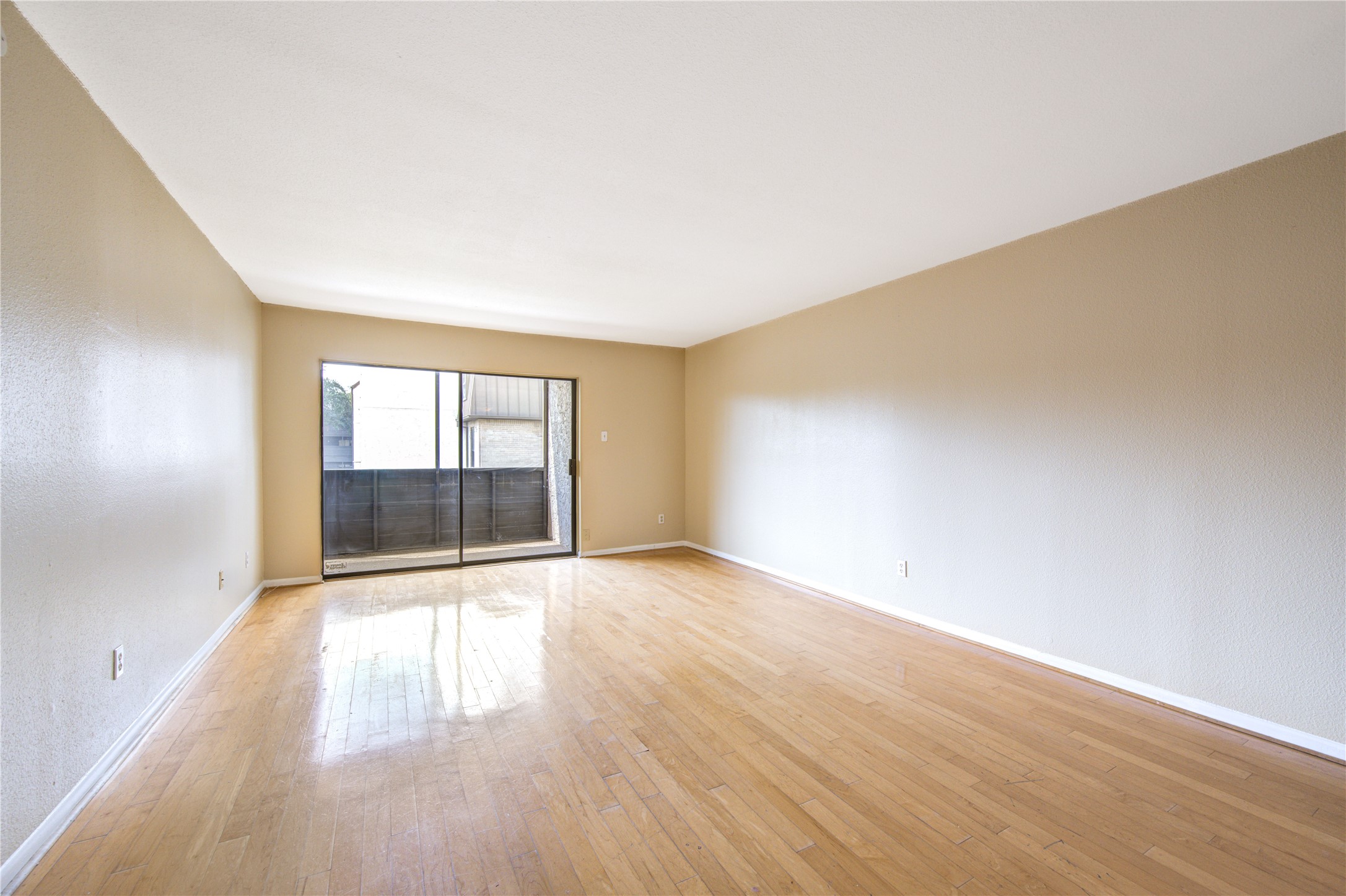 3055 Walnut Bend Lane, Unit 21 Houston, TX 77042 - Photo 1 of 31 an empty room with wooden floor and windows