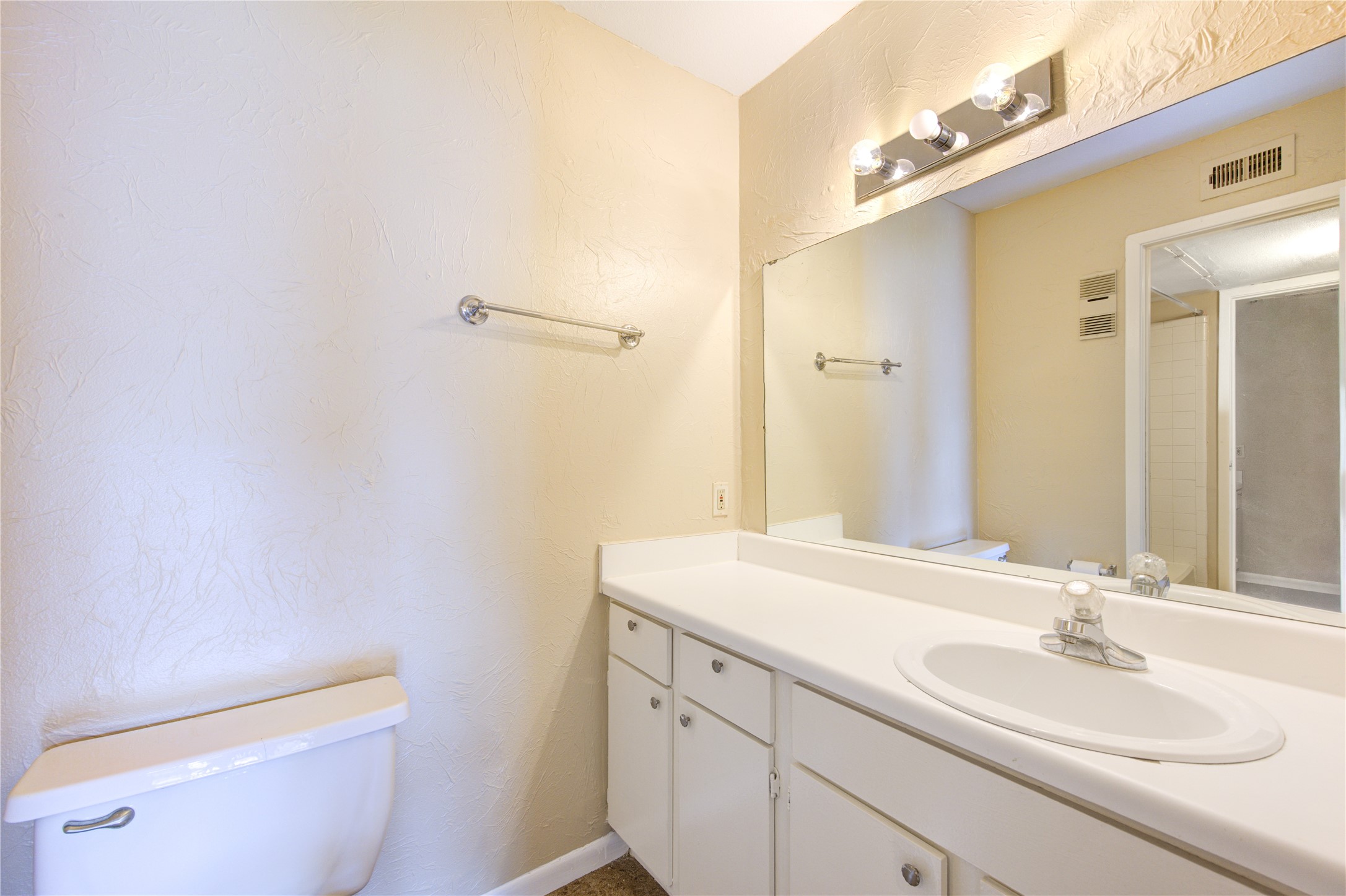 3055 Walnut Bend Lane, Unit 21 Houston, TX 77042 - Photo 23 of 31 a bathroom with a sink a toilet and a mirror
