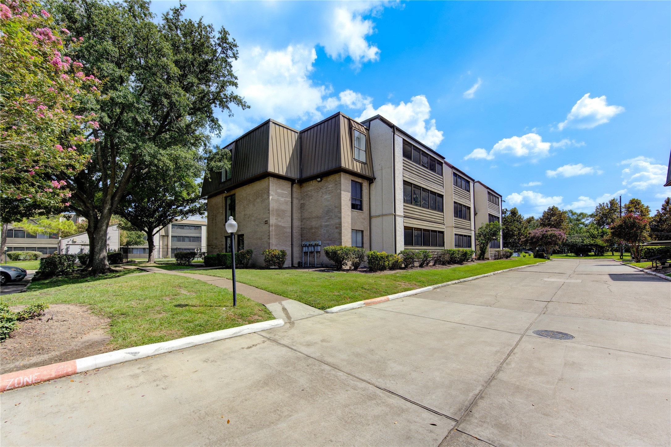 3055 Walnut Bend Lane, Unit 21 Houston, TX 77042 - Photo 29 of 31 a view of a big house with a big yard and large trees