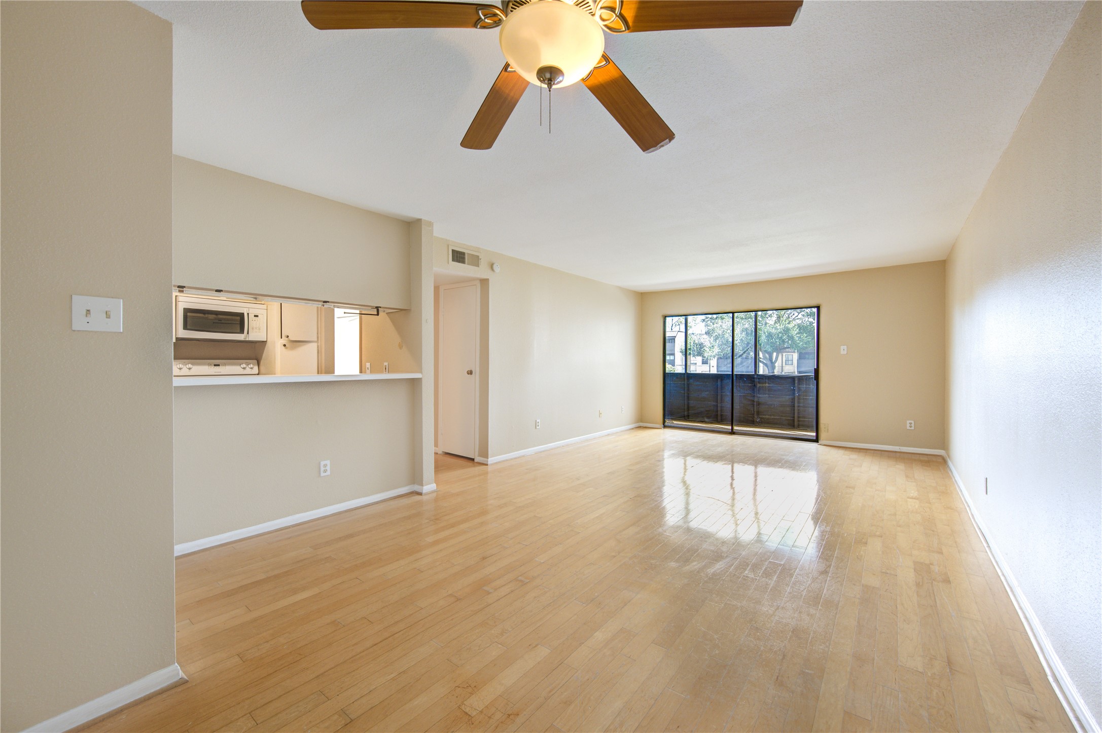 3055 Walnut Bend Lane, Unit 21 Houston, TX 77042 - Photo 3 of 31 a view of an empty room with window and wooden floor