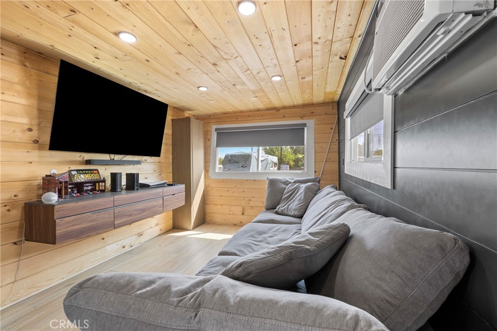 12149 Indiana Avenue, Unit 18 Riverside, CA 92503 - Photo 2 of 12 a living room with furniture and a flat screen tv