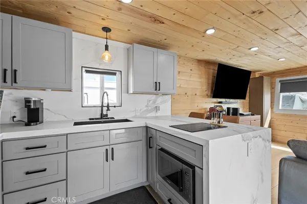 a kitchen with sink cabinets and microwave
