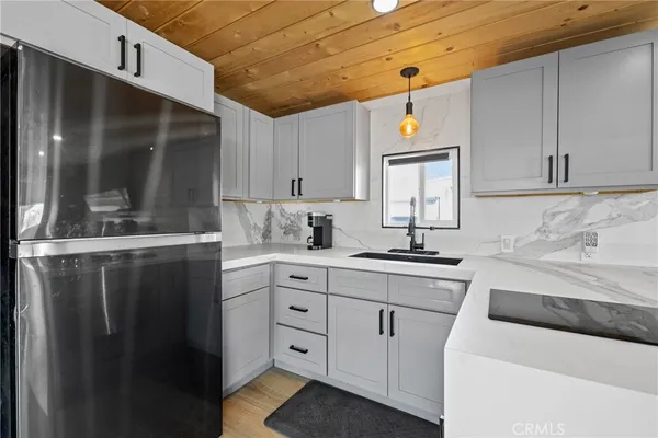 a kitchen with a sink cabinets and window