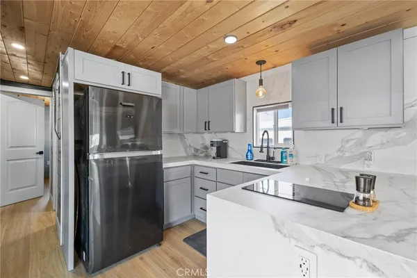 a kitchen with stainless steel appliances granite countertop a refrigerator and a sink