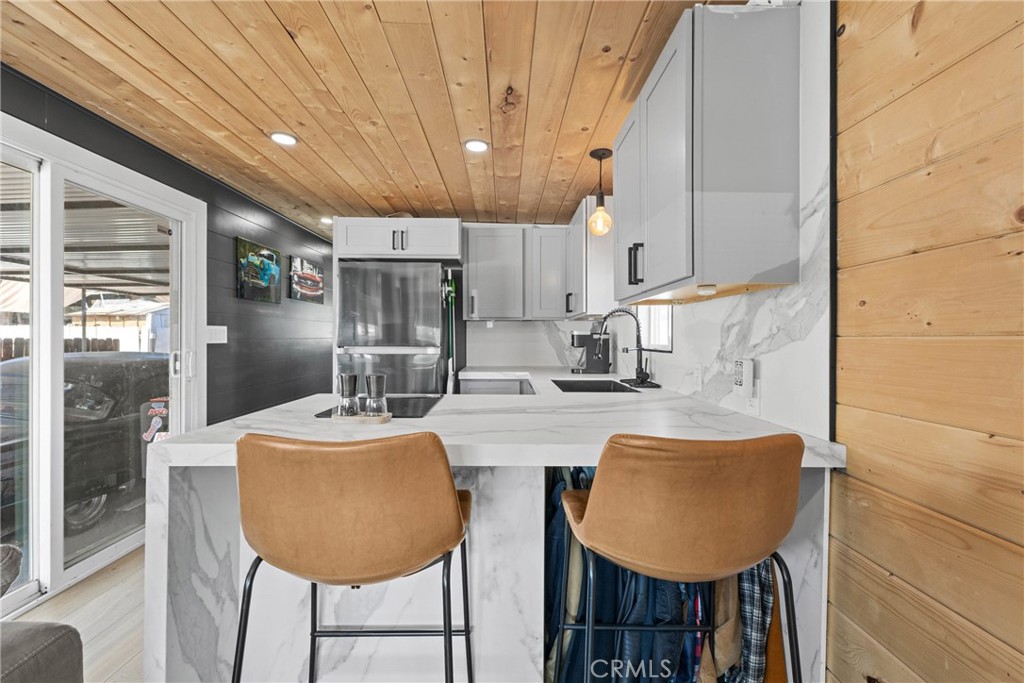 12149 Indiana Avenue, Unit 18 Riverside, CA 92503 - Photo 6 of 12 a dining room with kitchen island furniture a chandelier and kitchen view