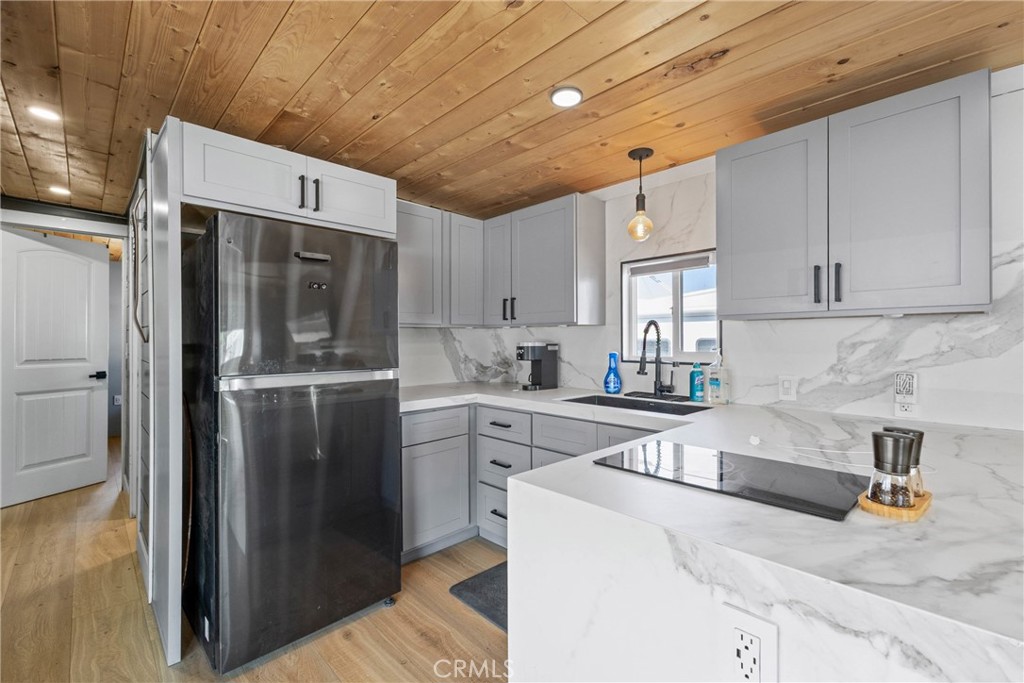 12149 Indiana Avenue, Unit 18 Riverside, CA 92503 - Photo 7 of 12 a kitchen with stainless steel appliances granite countertop a refrigerator and a sink