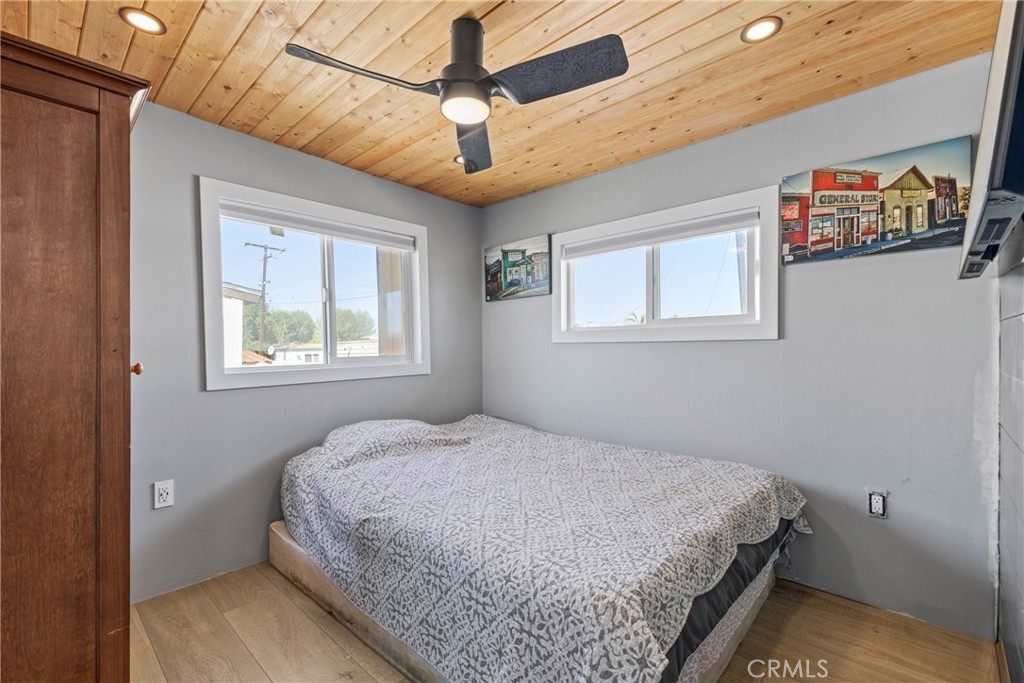 12149 Indiana Avenue, Unit 18 Riverside, CA 92503 - Photo 8 of 12 a bedroom with a bed and a window