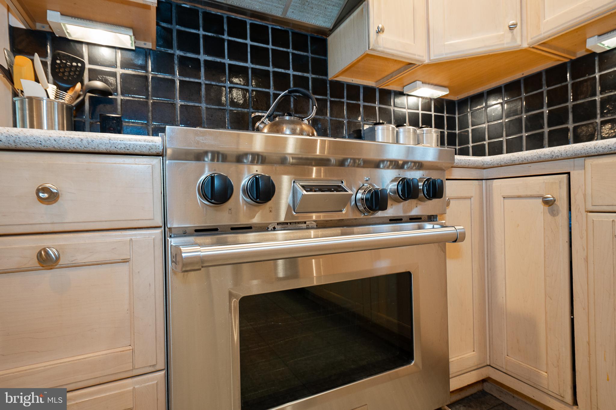 9 Shirley Road Narberth, PA 19072 - Photo 34 of 87 a stove top oven sitting inside of a kitchen with stainless steel appliances wooden floor